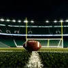 Фотореалістичне зображення футбольного поля під стадіонними вогнями вночі, з одним футбольним м'ячем на траві. Кінематографічне освітлення, 8k, гіперреалістичне.